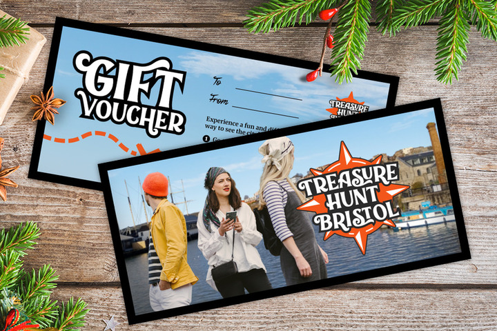 A gift voucher for Treasure Hunt Bristol on a table covered with Christmas decorations